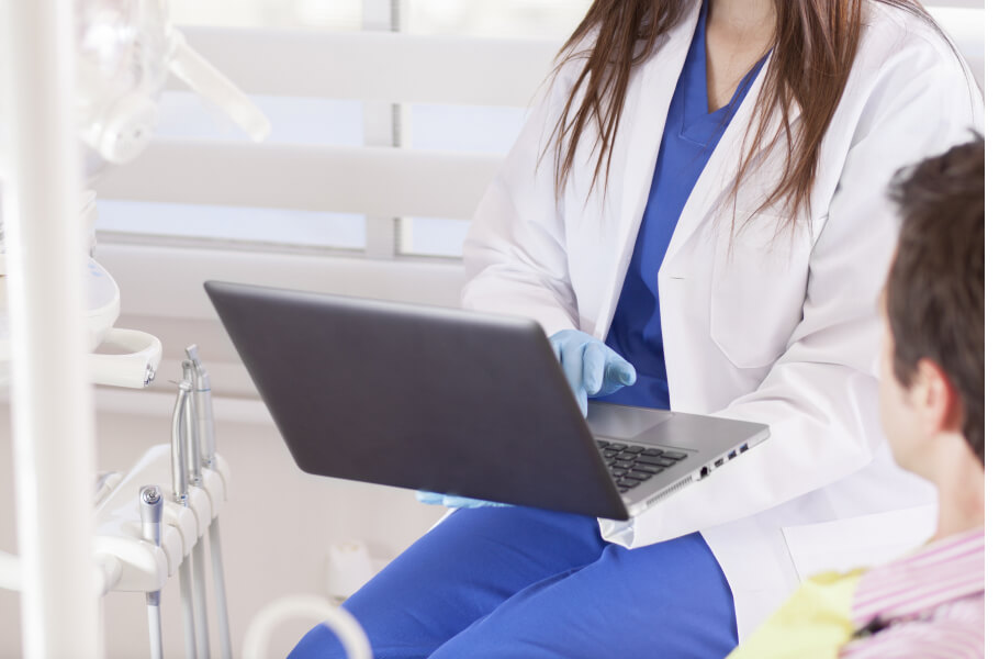 A dentist checking the record of patient