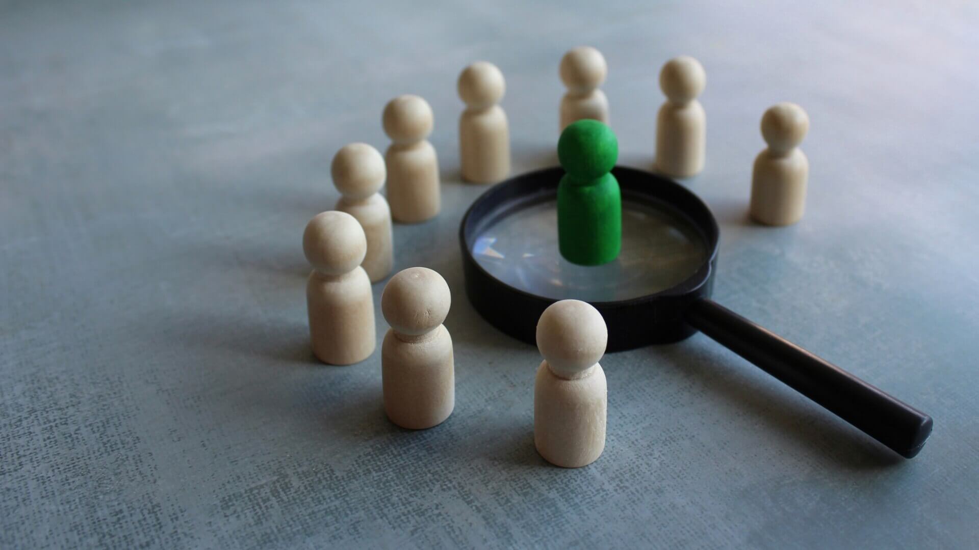 A human figure above the black magnifying glass