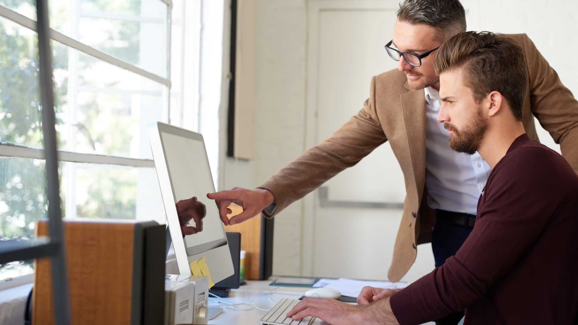 A man mentoring his apprentice for better web design