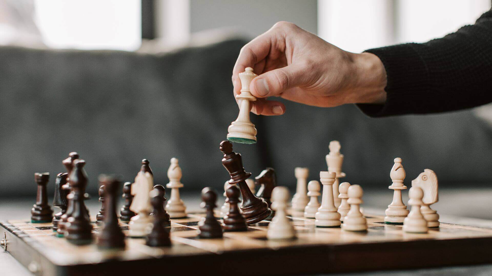 A man playing chess with a strategy pattern