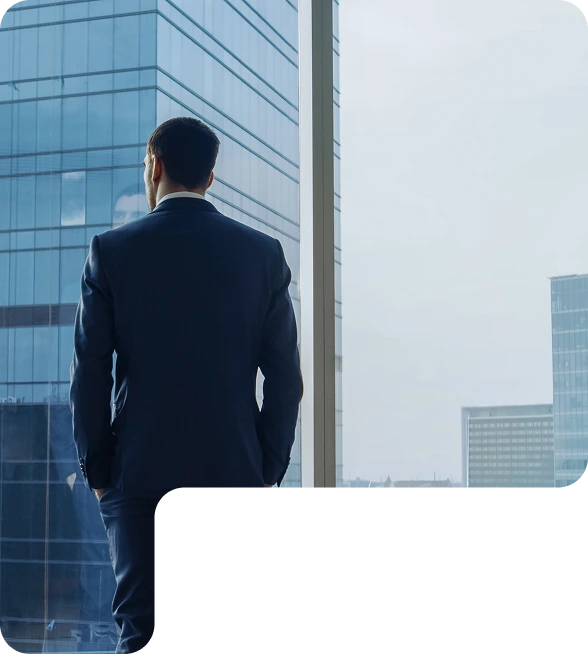 A man standing on a rooftop with a background of tall buildings