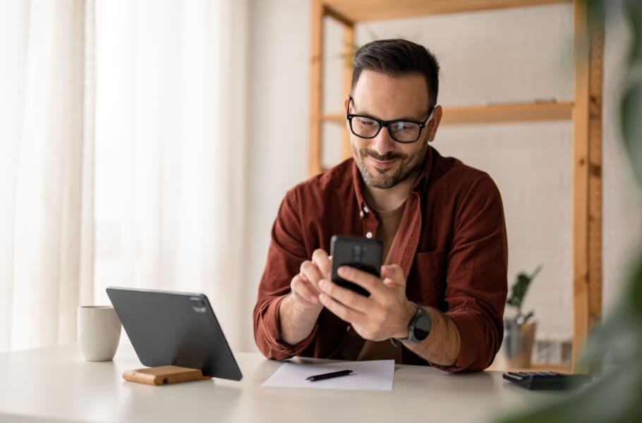 A person smilling while using phone