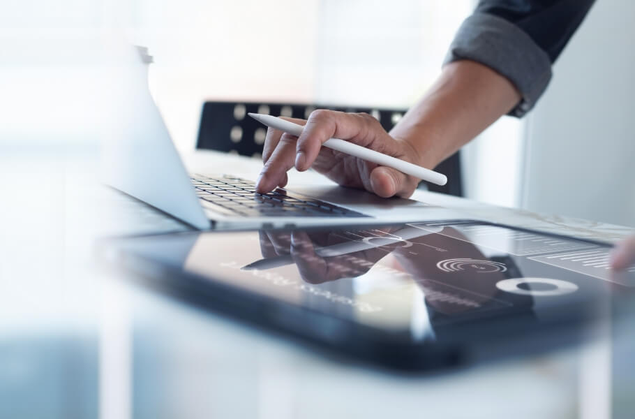 A person using laptop and tablet