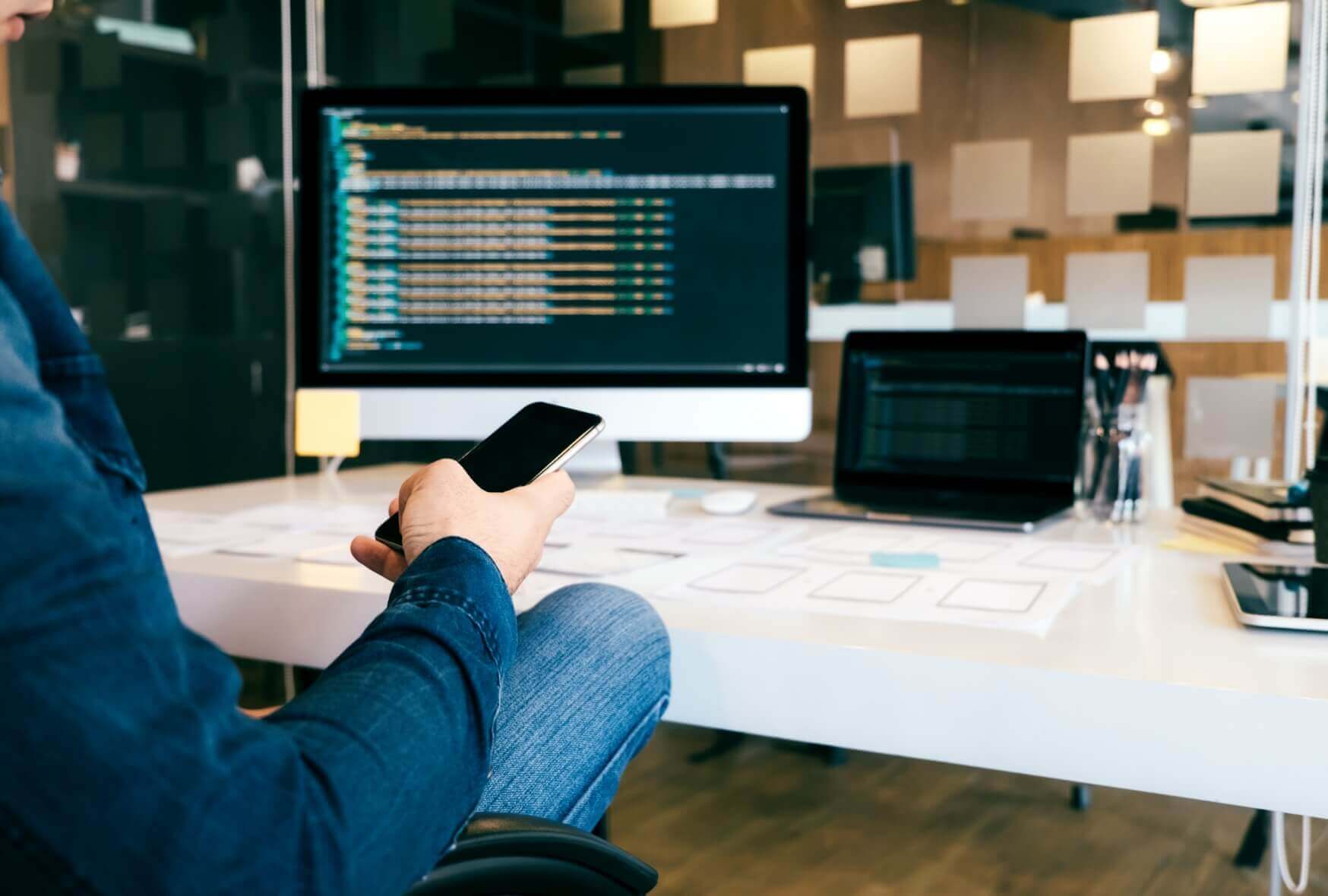 A programmer using a phone while on break