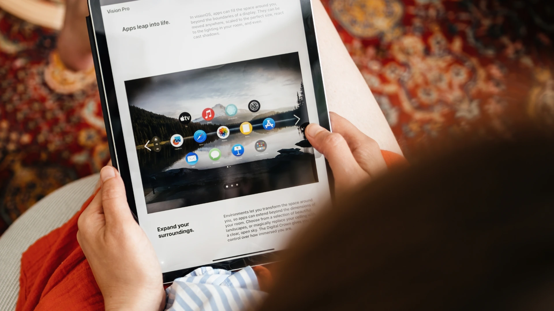 A woman holding and reading to an iPad