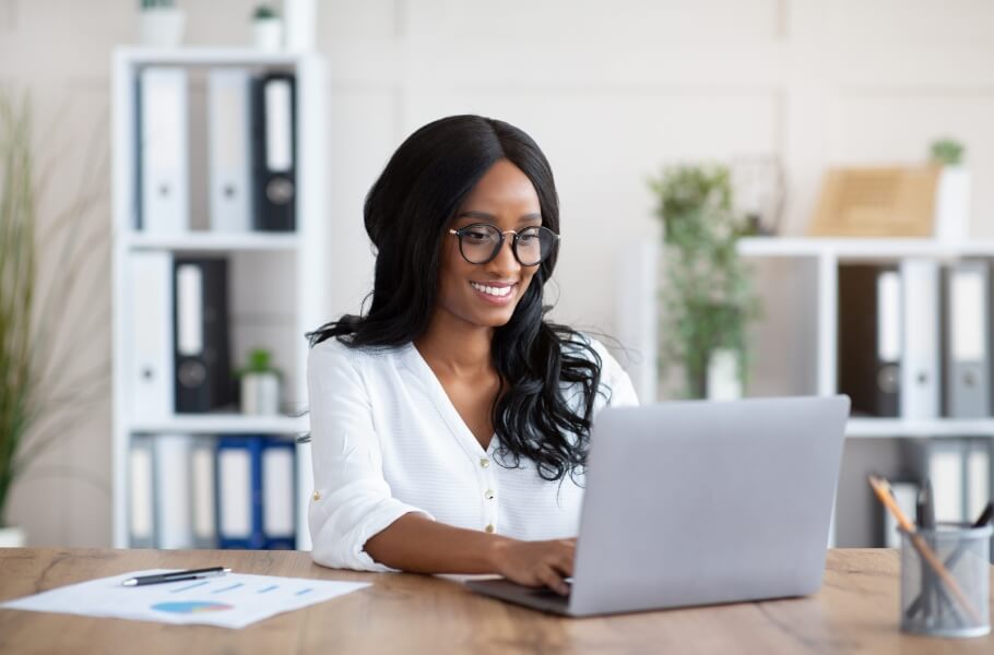 A women happy while using laptop