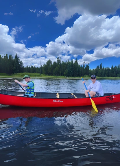 Aaron and his son in a boat