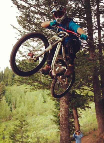 Aaron is mountain biking on a mountain trail