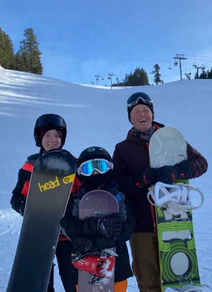 Aaron snowboarding with other people