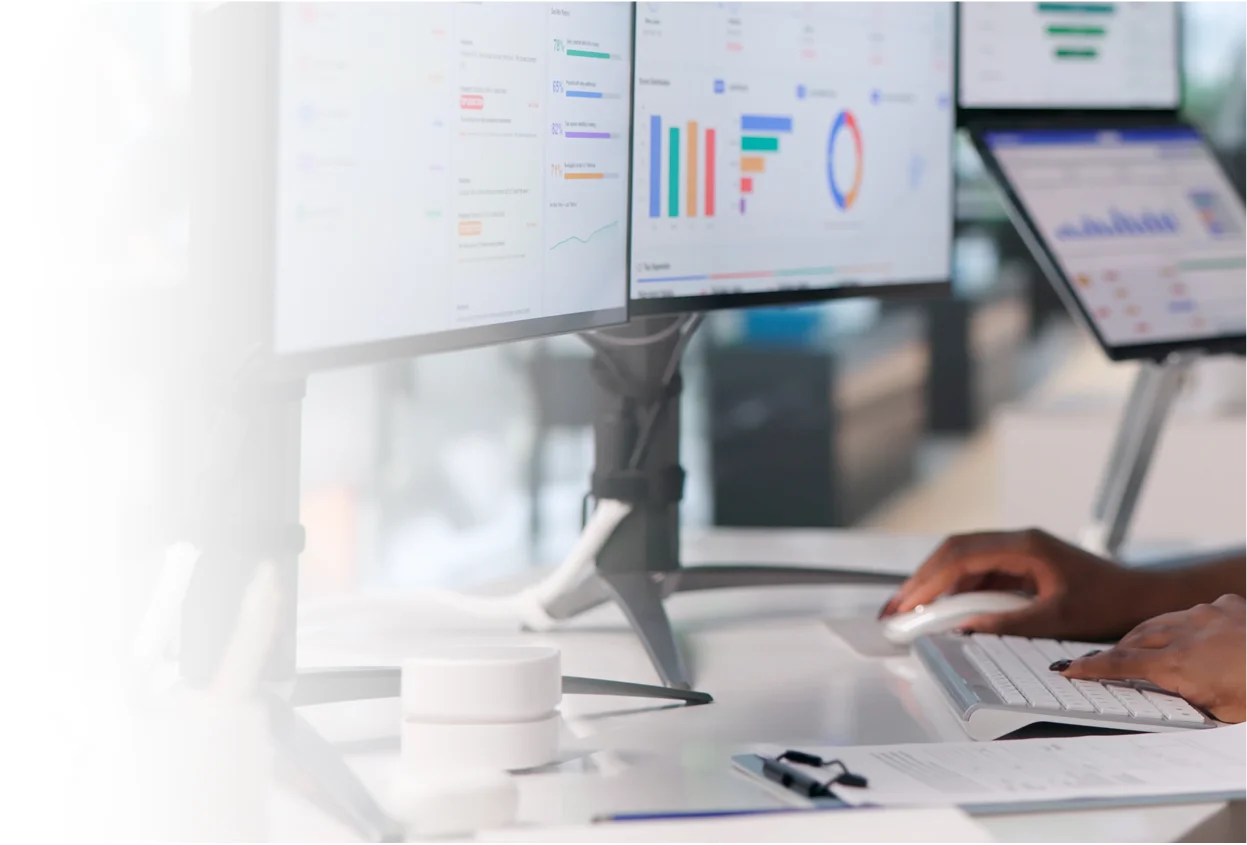 Business analytics displayed on computer screens