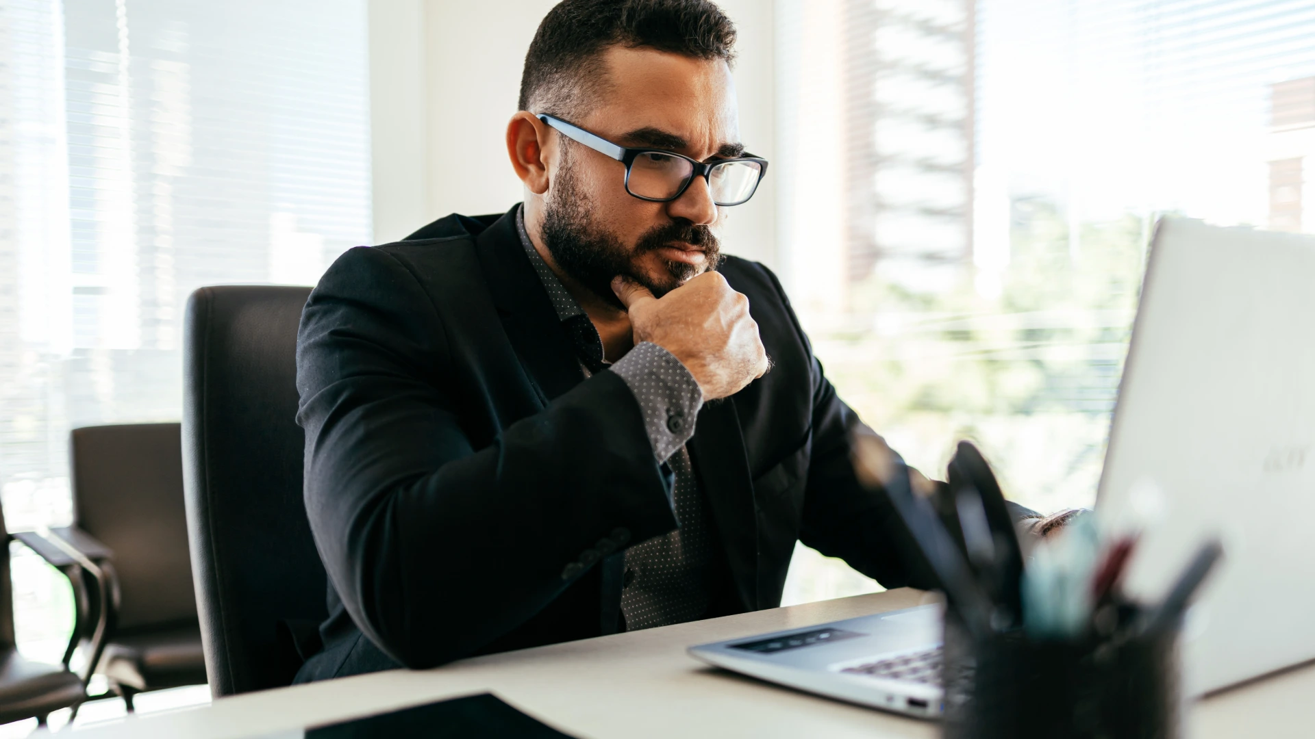 Businessman working on laptop in modern office