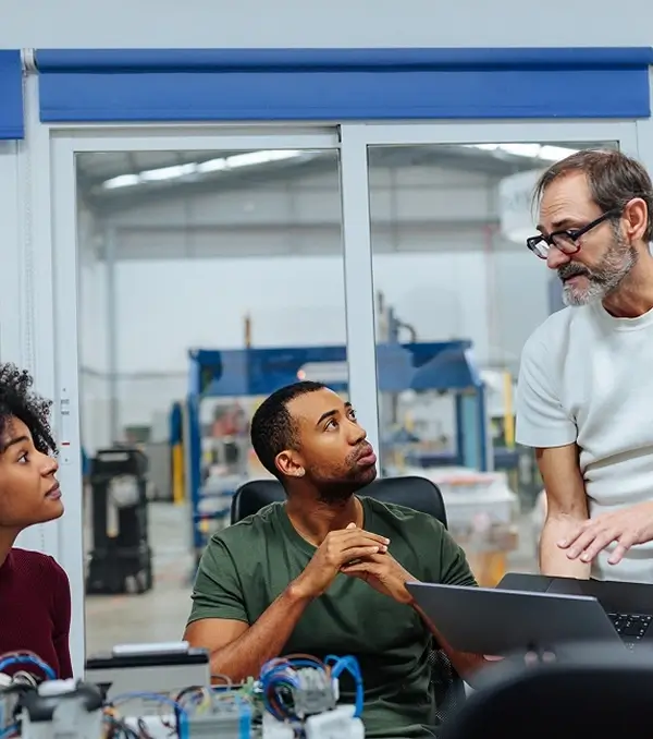 Engineers discussing equipment in a manufacturing facility