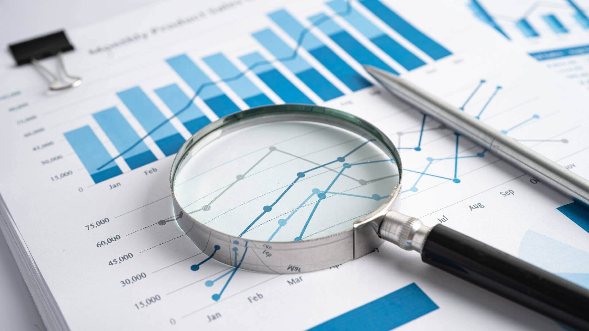 Magnifying Glass on Charts Graphs Paper