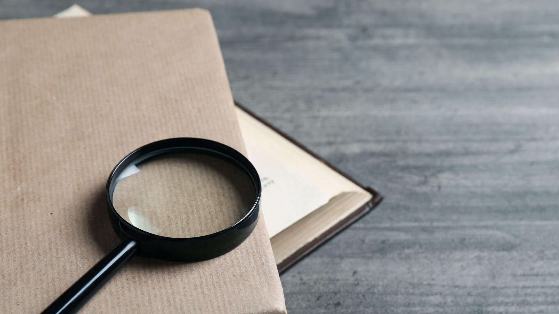 Magnifying glass above the brown book