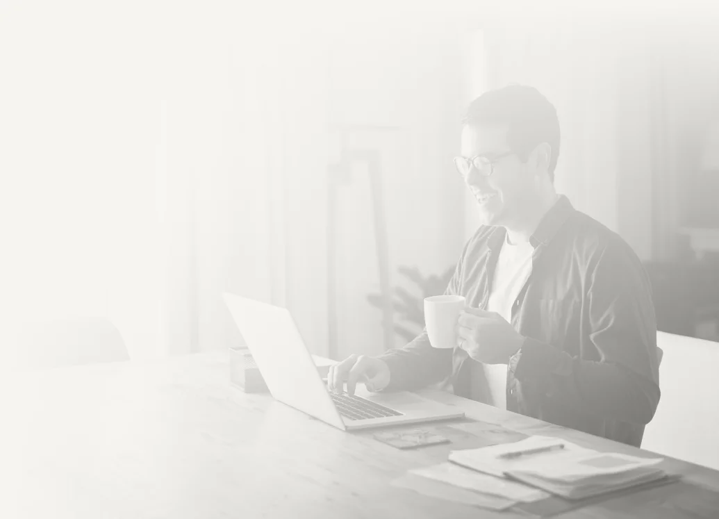 Man working on a laptop with coffee
