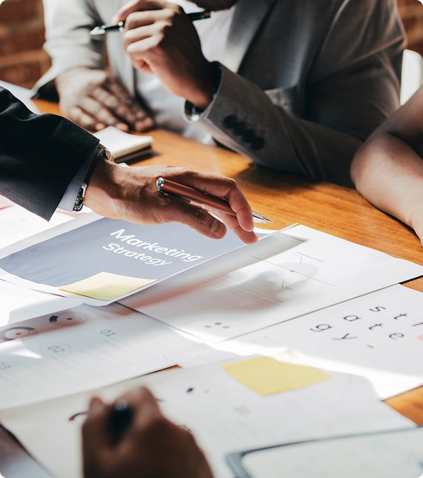 People review marketing documents during a team meeting