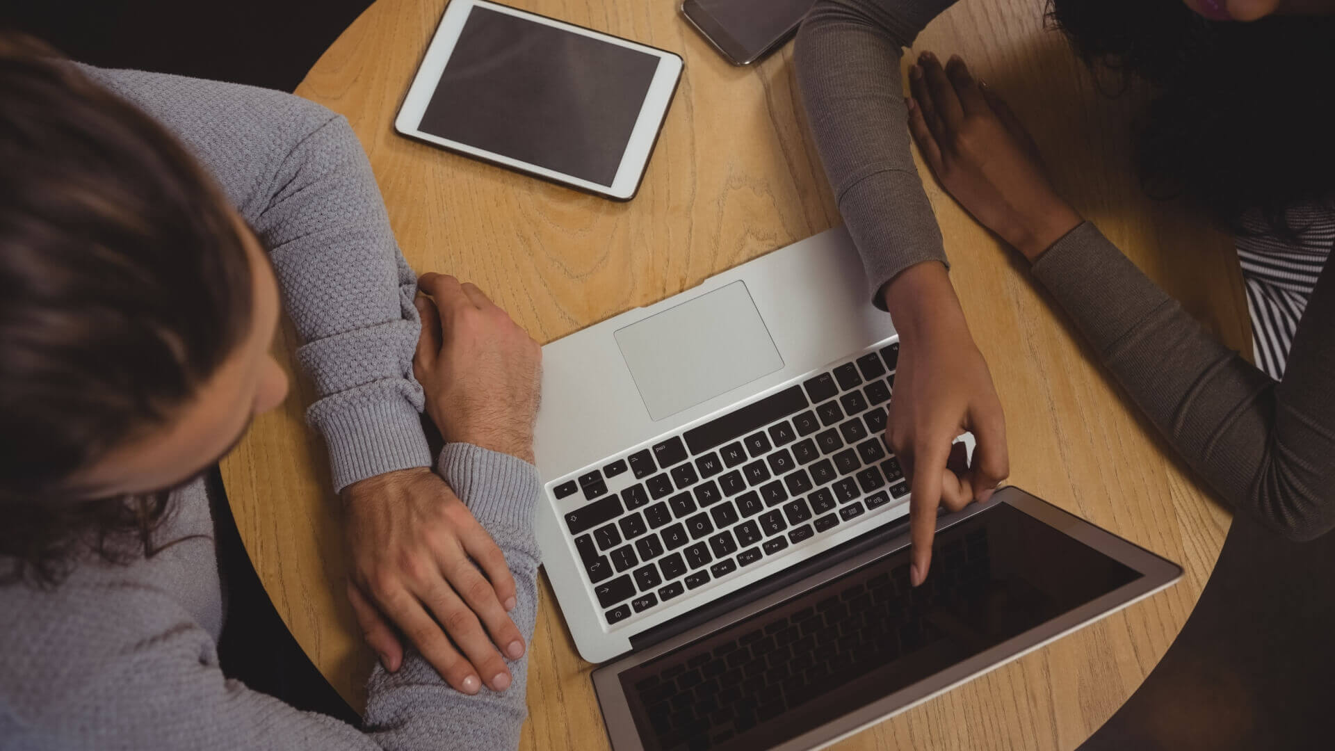 Person pointing at laptop