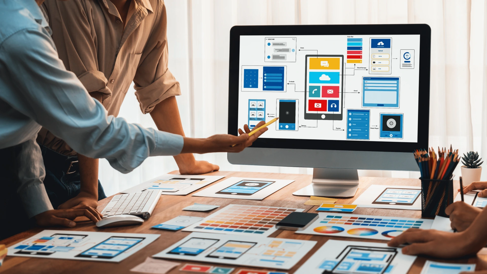 Shot of front-end developer team brainstorming UI and UX designs for mobile app on laptop computer screen