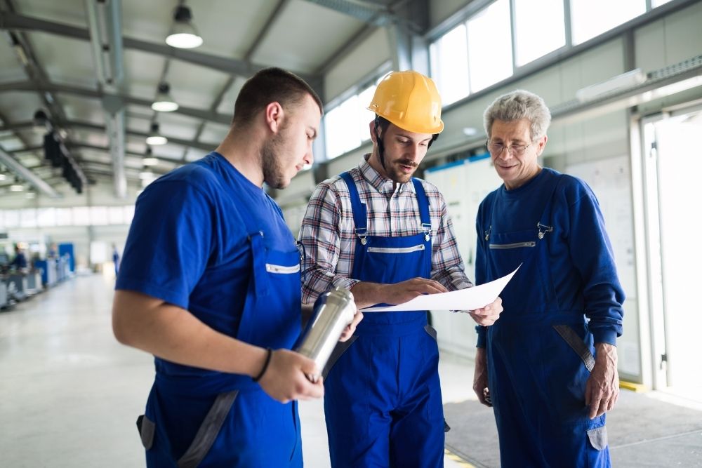 Supplier with engineer checking on production in factory