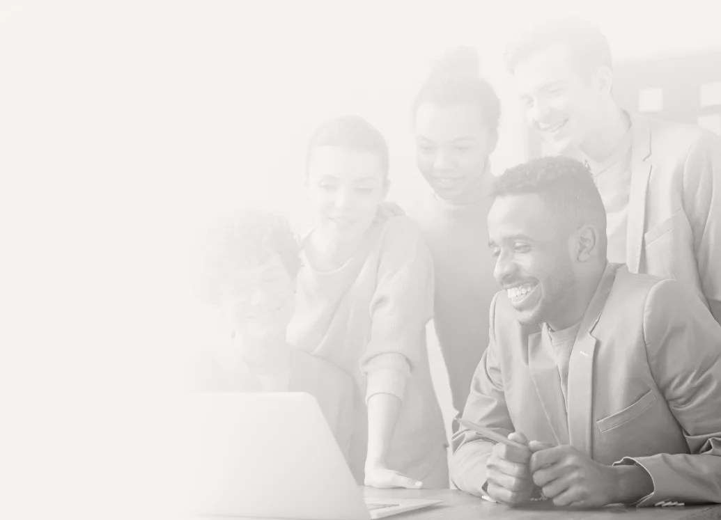 Team collaborating around a laptop