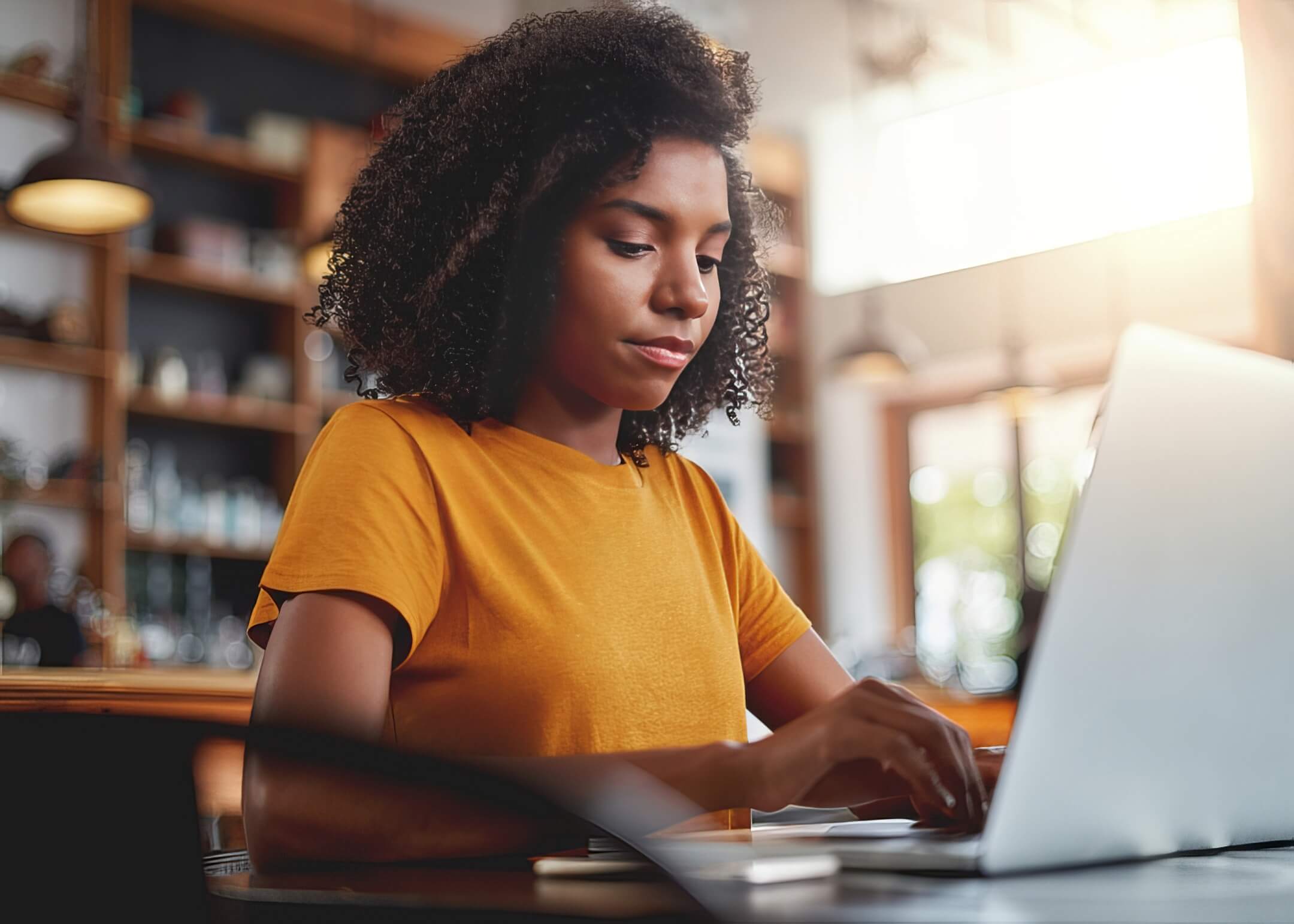 Women wearing yellow shirt using laptop