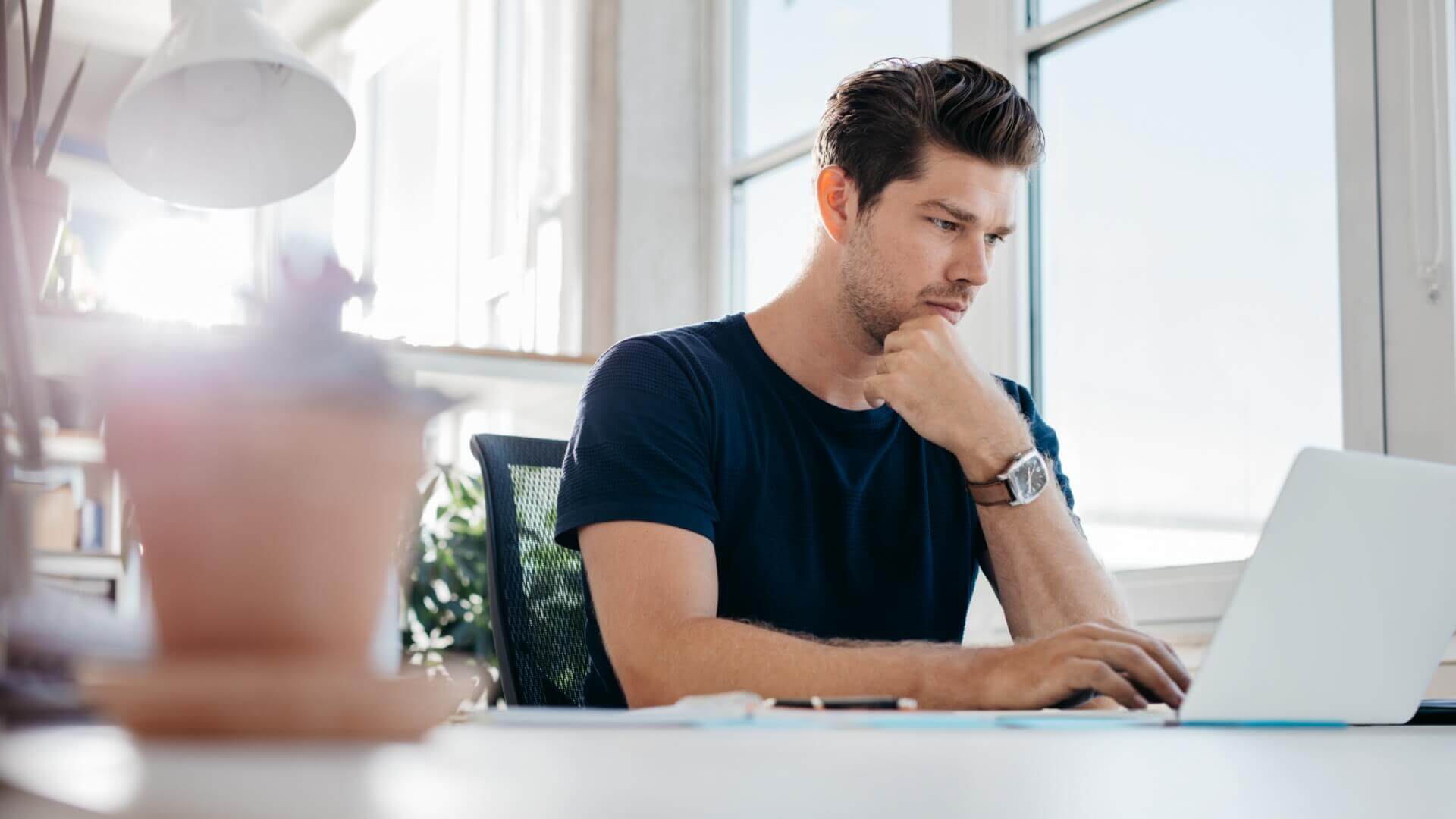 Thinking man at front of laptop