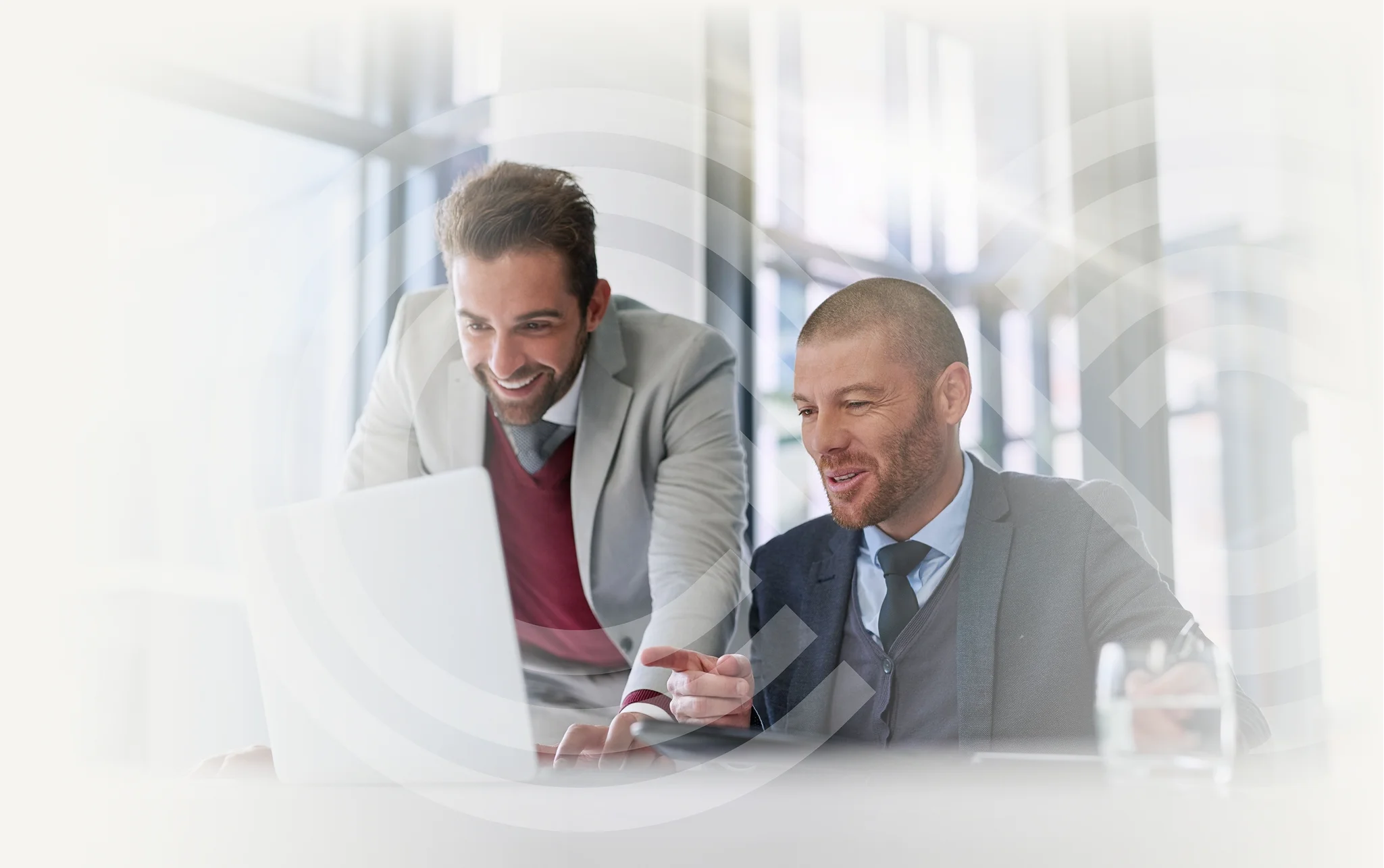 Two businessmen reviewing a laptop together