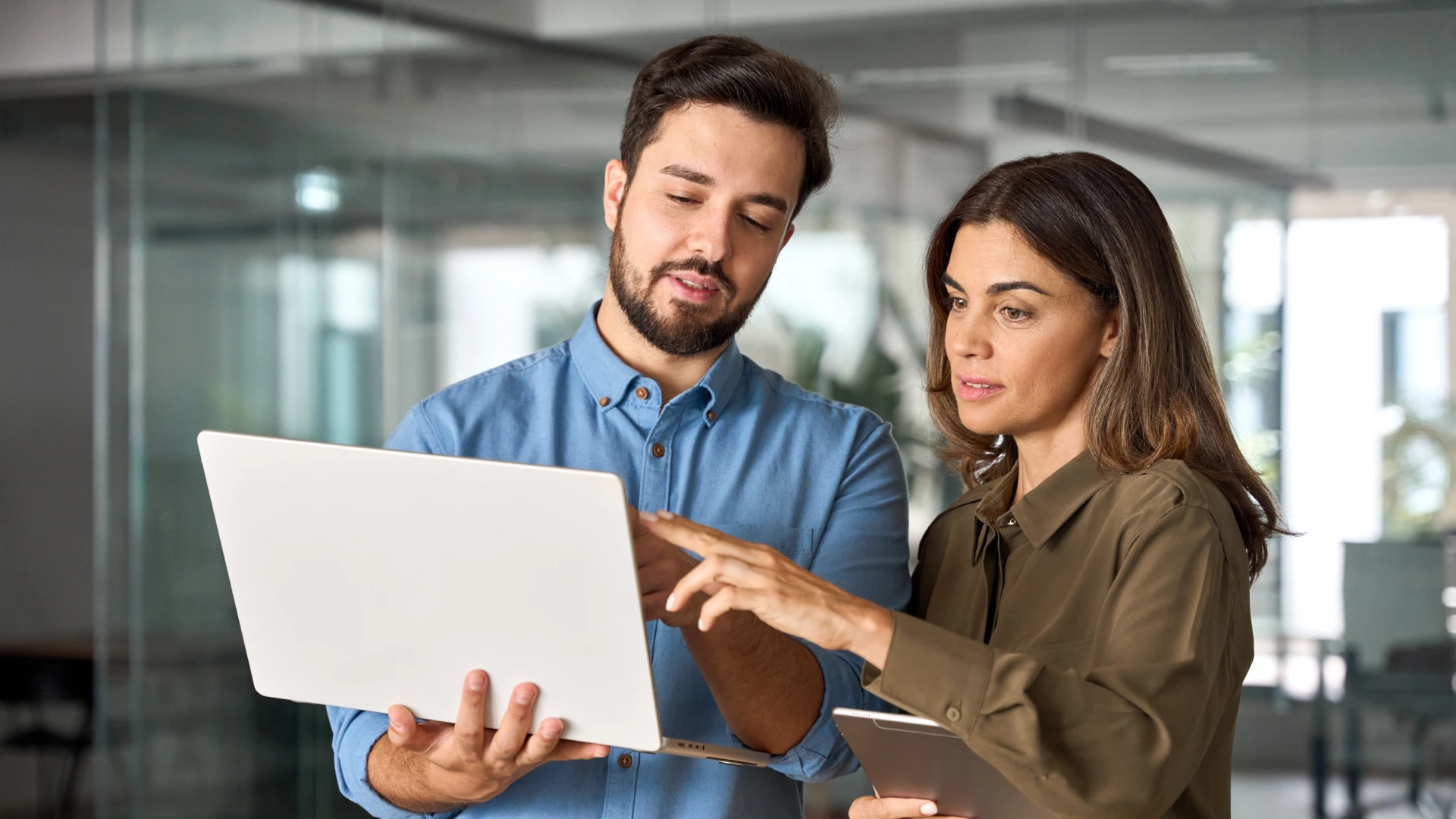 Two busy professional business people working in office with computer.