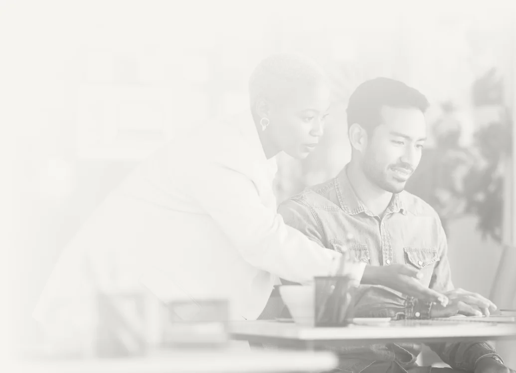 Two coworkers reviewing documents together