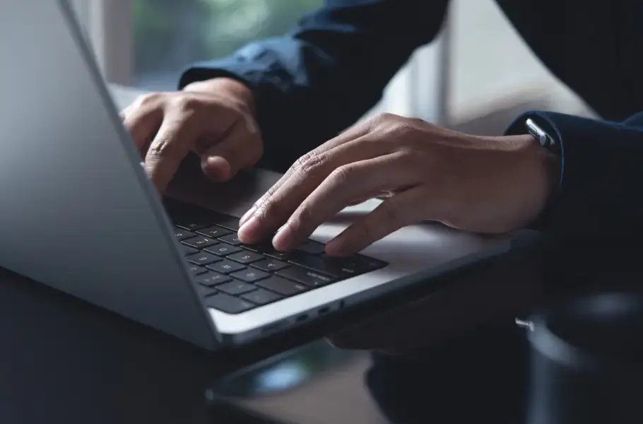 Person typing on a laptop at a desk