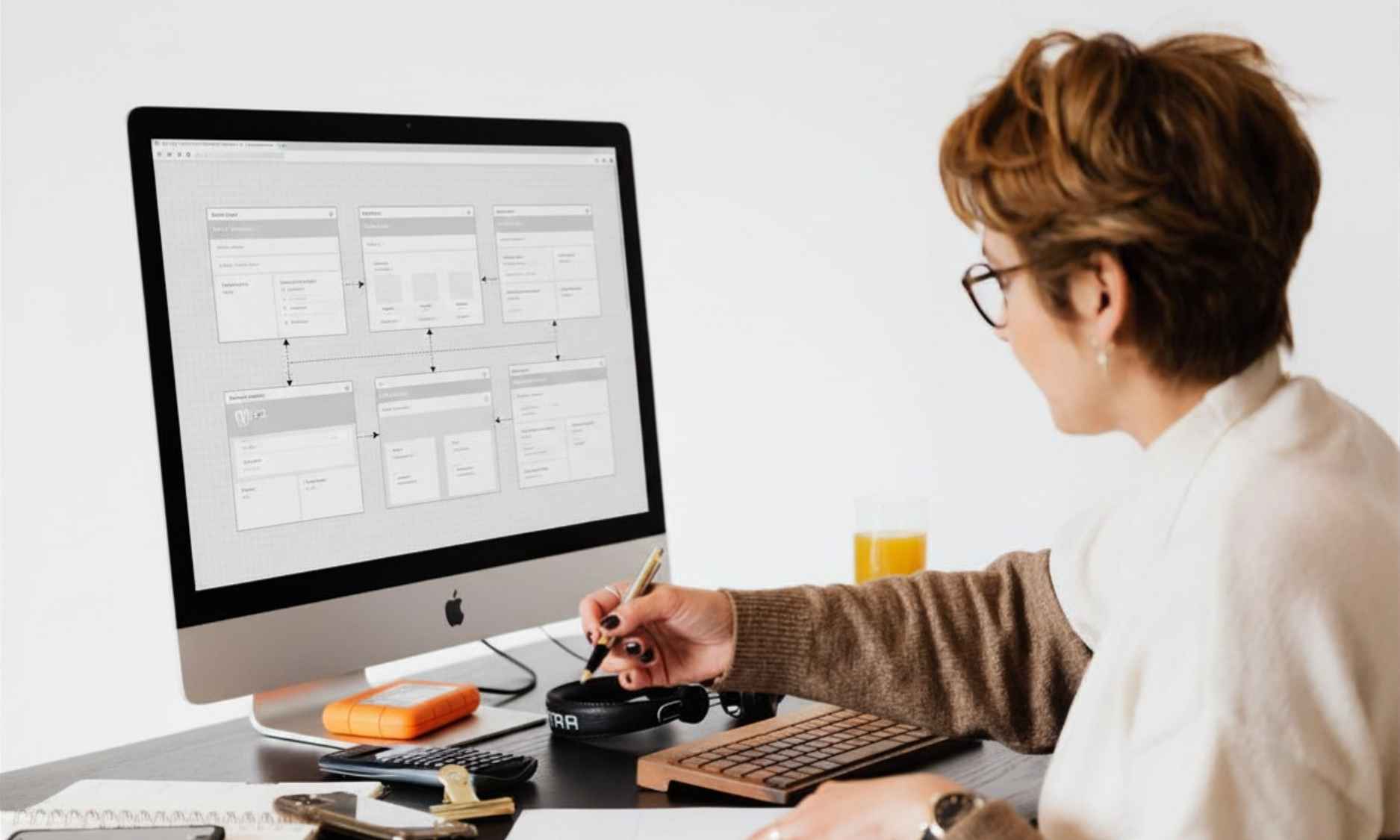 Web developer looking at the website wireframe and taking notes