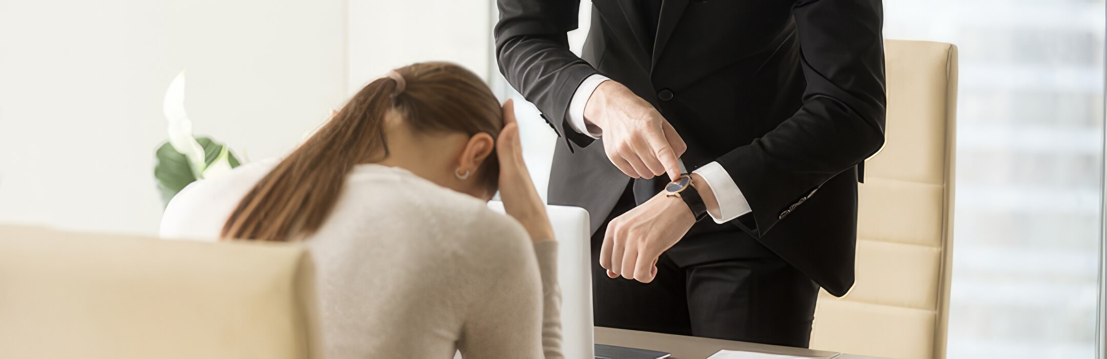 woman being scolded by boss for being late