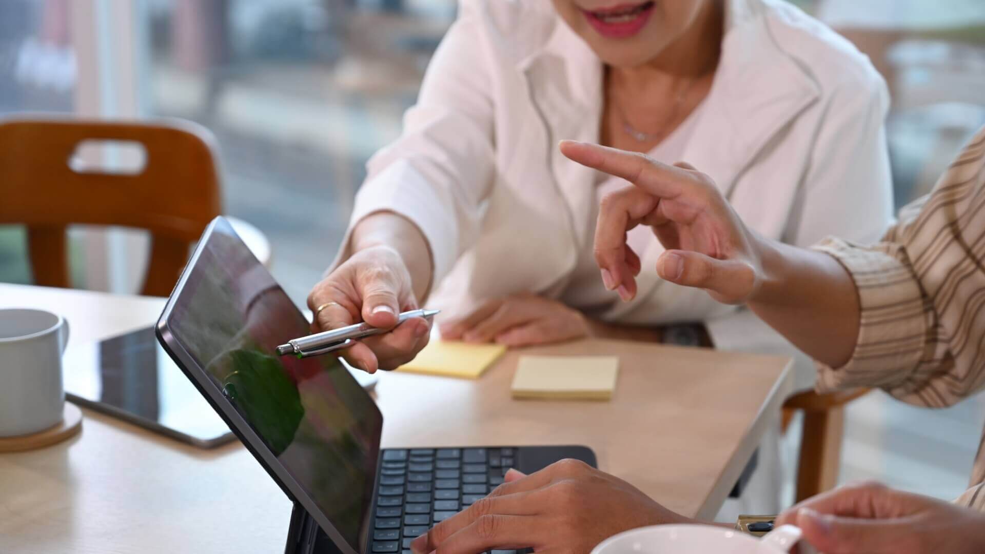 Women pointing something in tablet