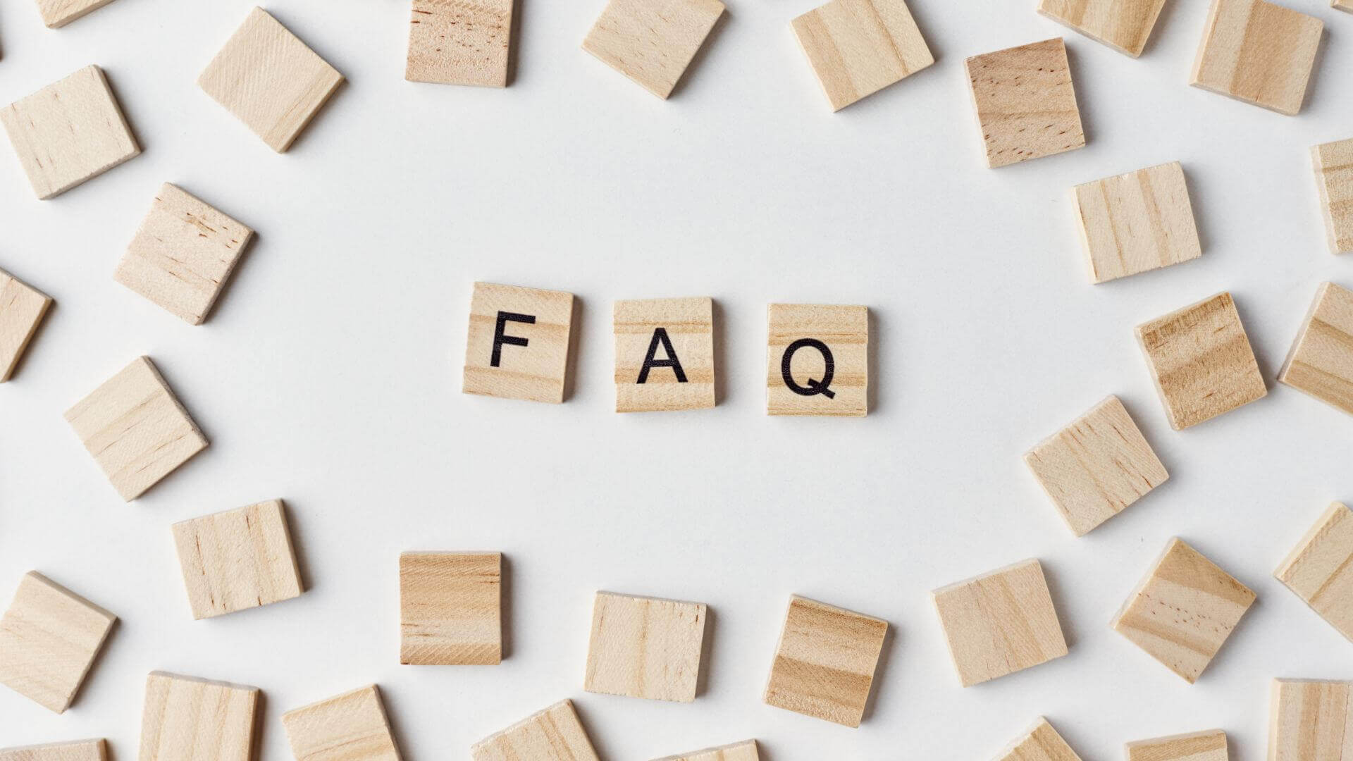 Wooden Blocks with Abbreviation FAQ on White Background