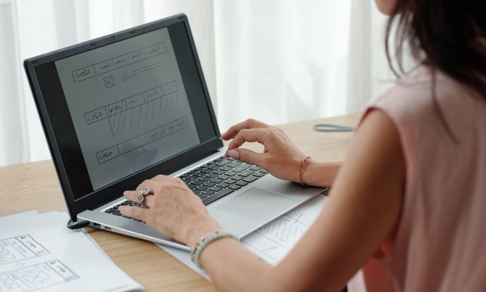 analyzing website design on laptop with keen focus