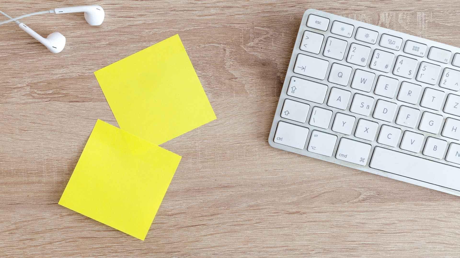 blank sticky notes and a keyboard on the table