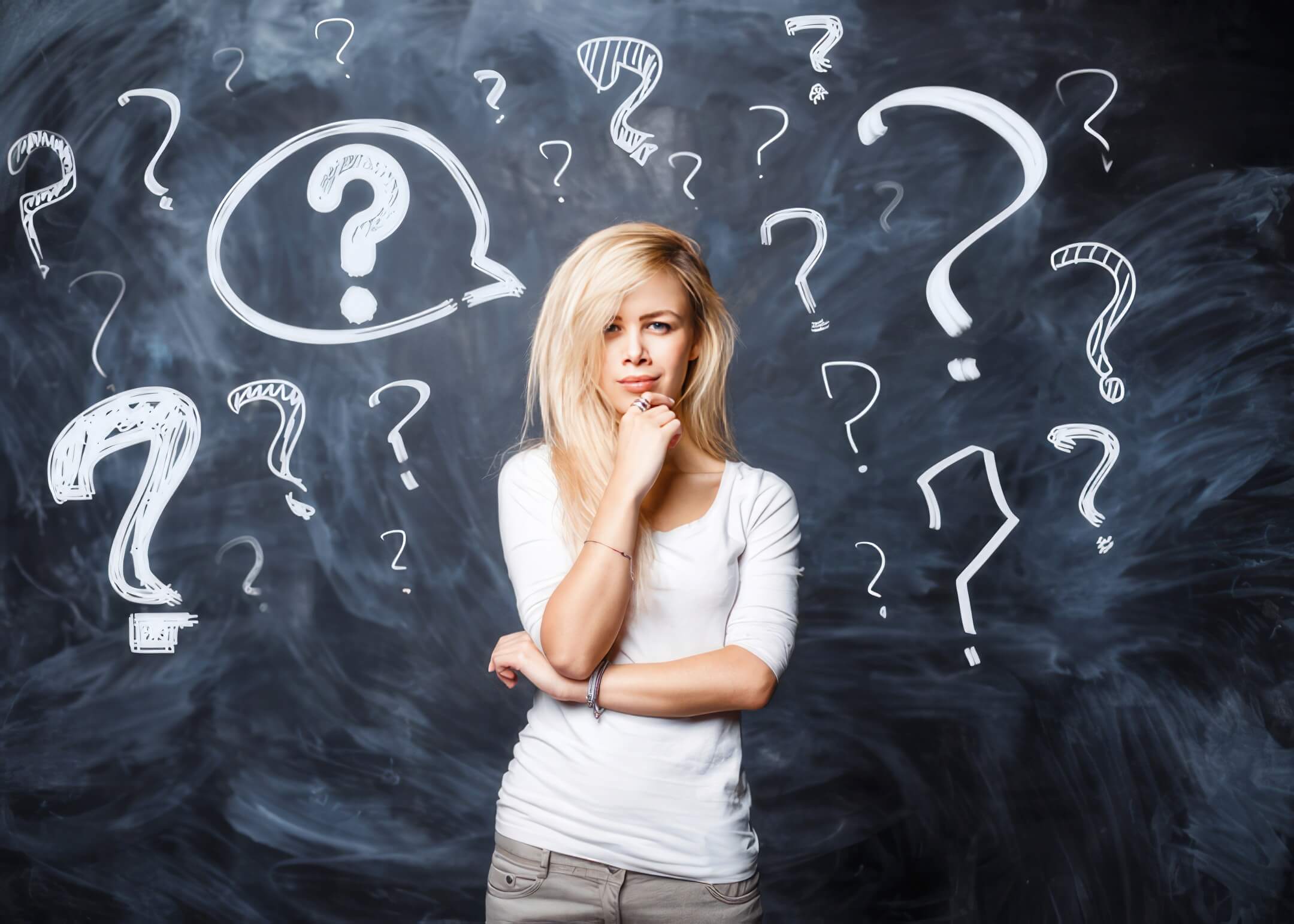 blonde girl in a white T shirt asks herself a question on a black background