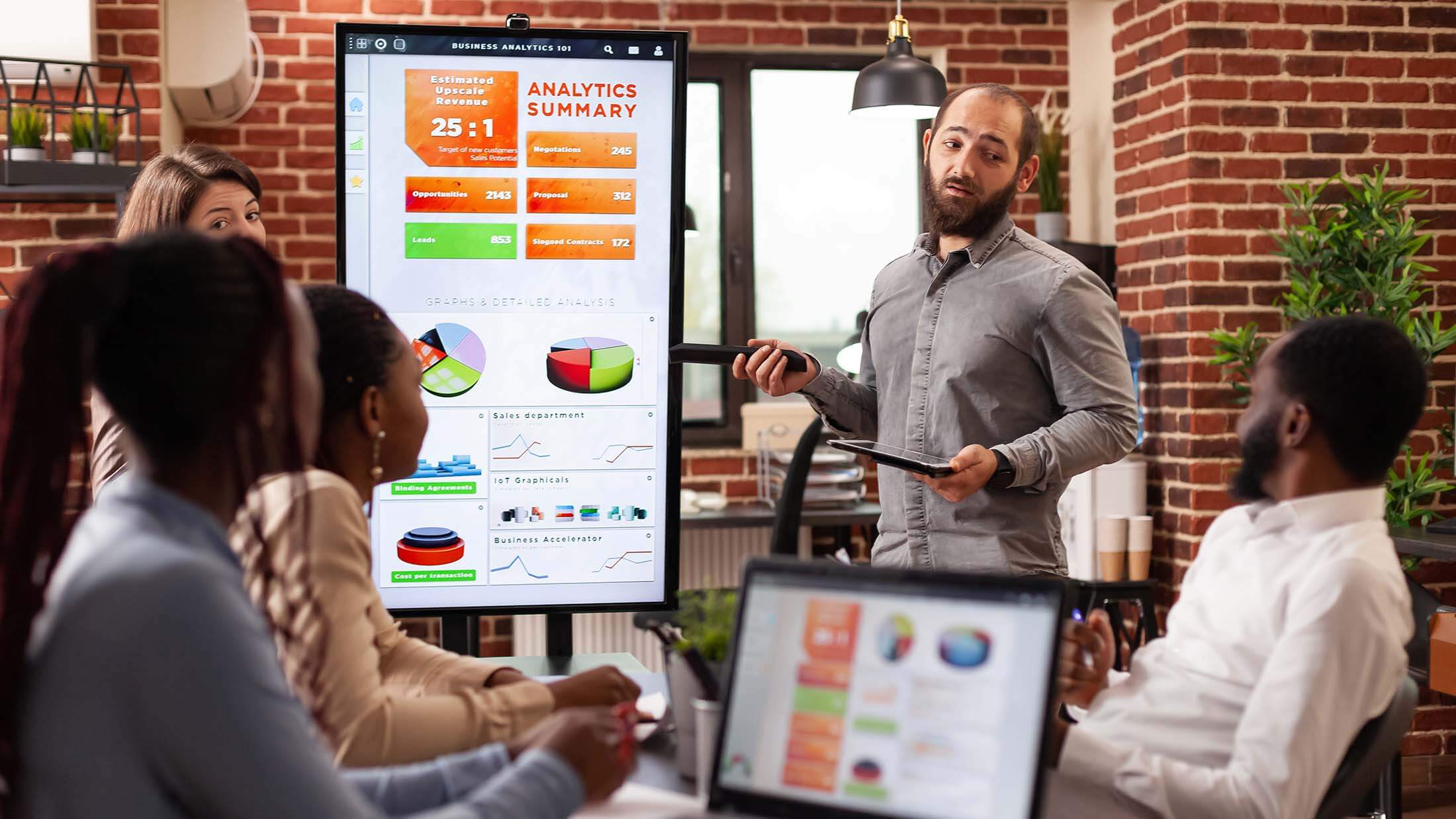 businessman-standing-beside-monitor-showing-manage