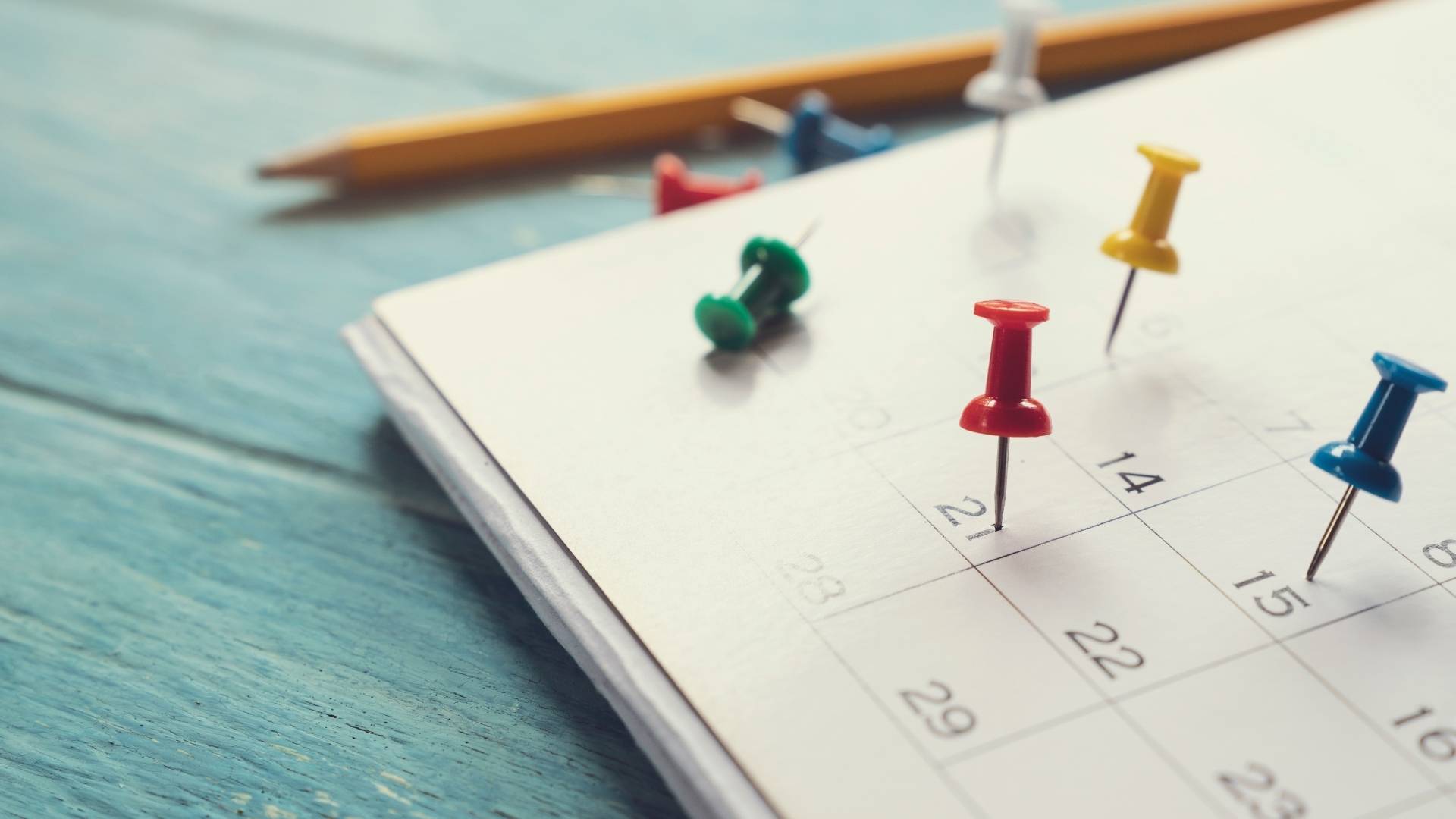 calendar on the table with pins