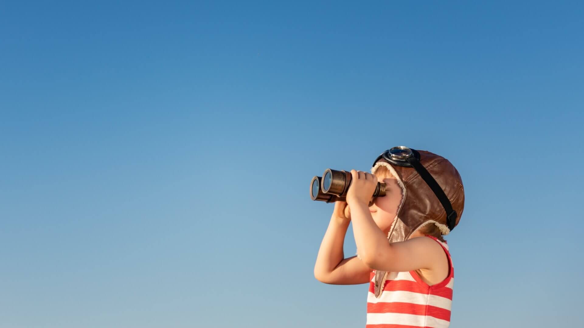 child checking with binoculars