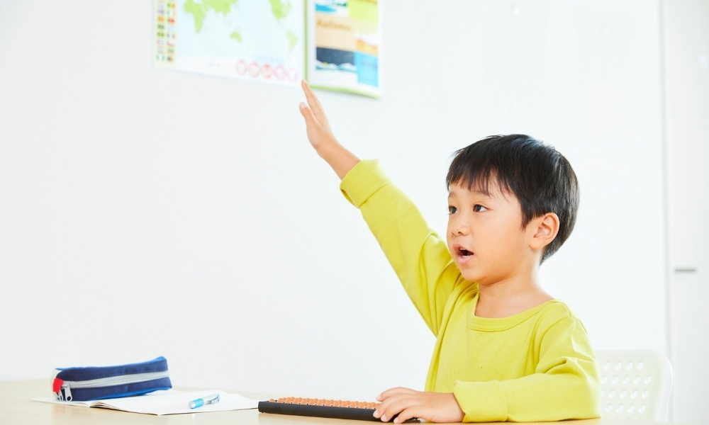 child raising his hand