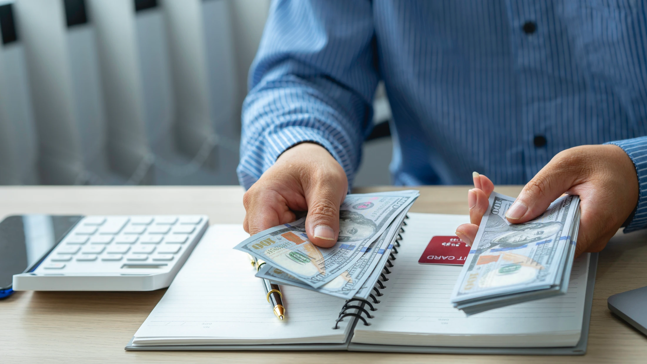 Close up of man with calculator counting money