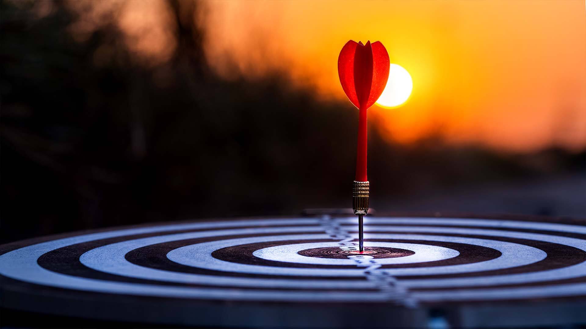 close-up-red-dart-arrow-hitting-target