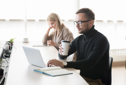 designer working on his laptop in a coffee shop