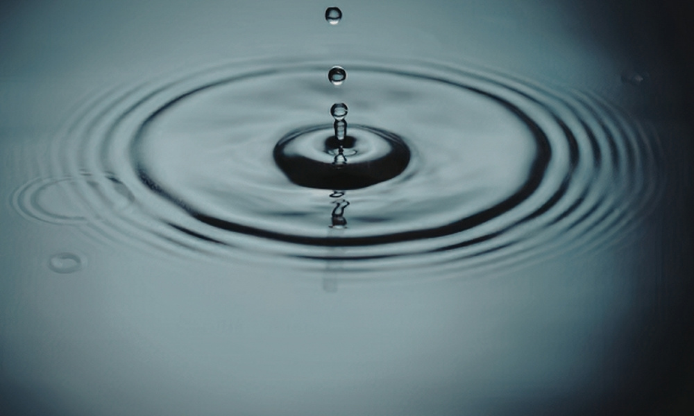drop of water rippling in a pond