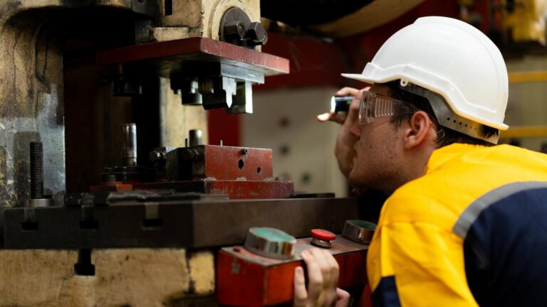 engineer inspecting a lathe machine
