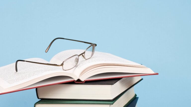 eye glasses on top of books