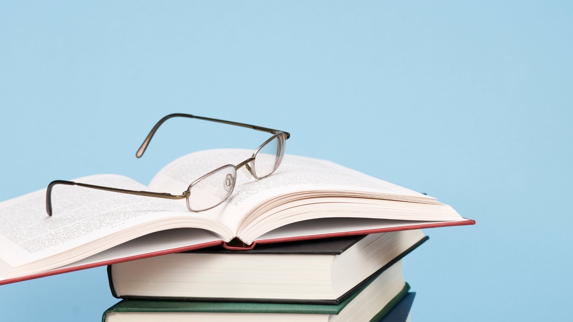 eye glasses on top of books