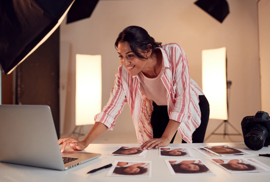 female photographer editing images on her laptop