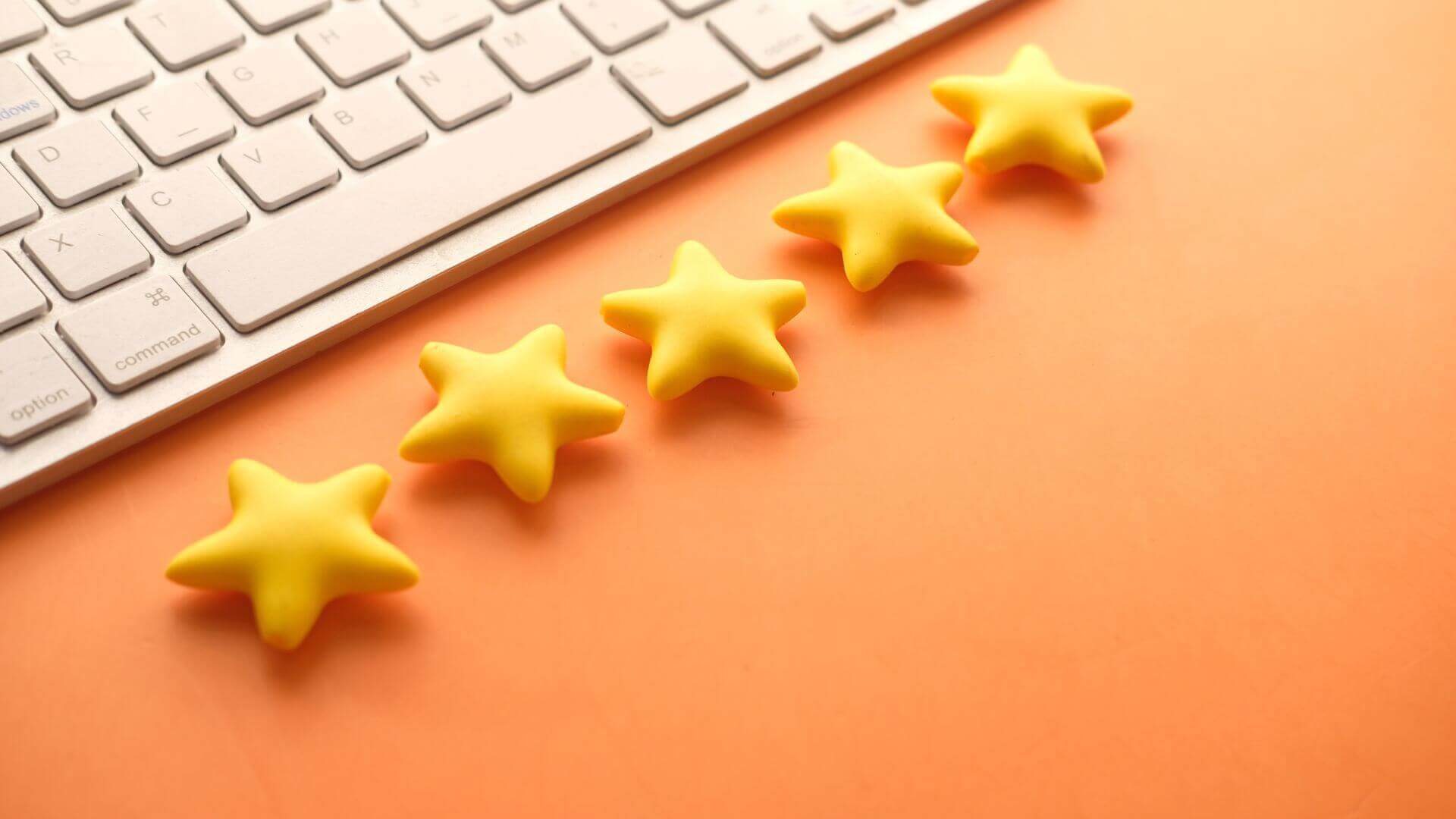 golden stars on orange background with a laptop